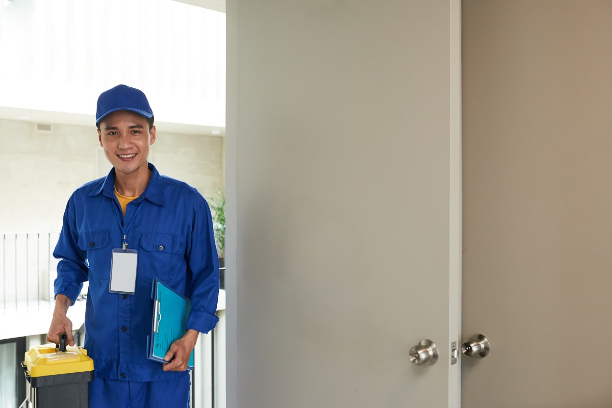 plumber holding a toolkit on the doorstep